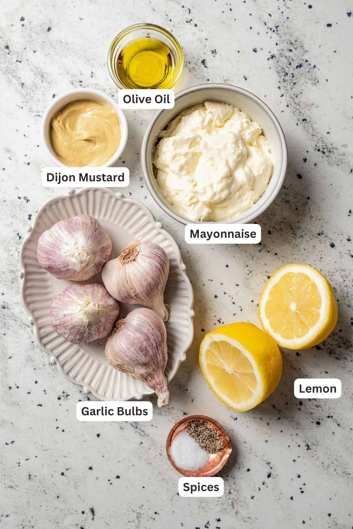 Ingredients for roasted garlic aioli with text labels over top of each ingredient.