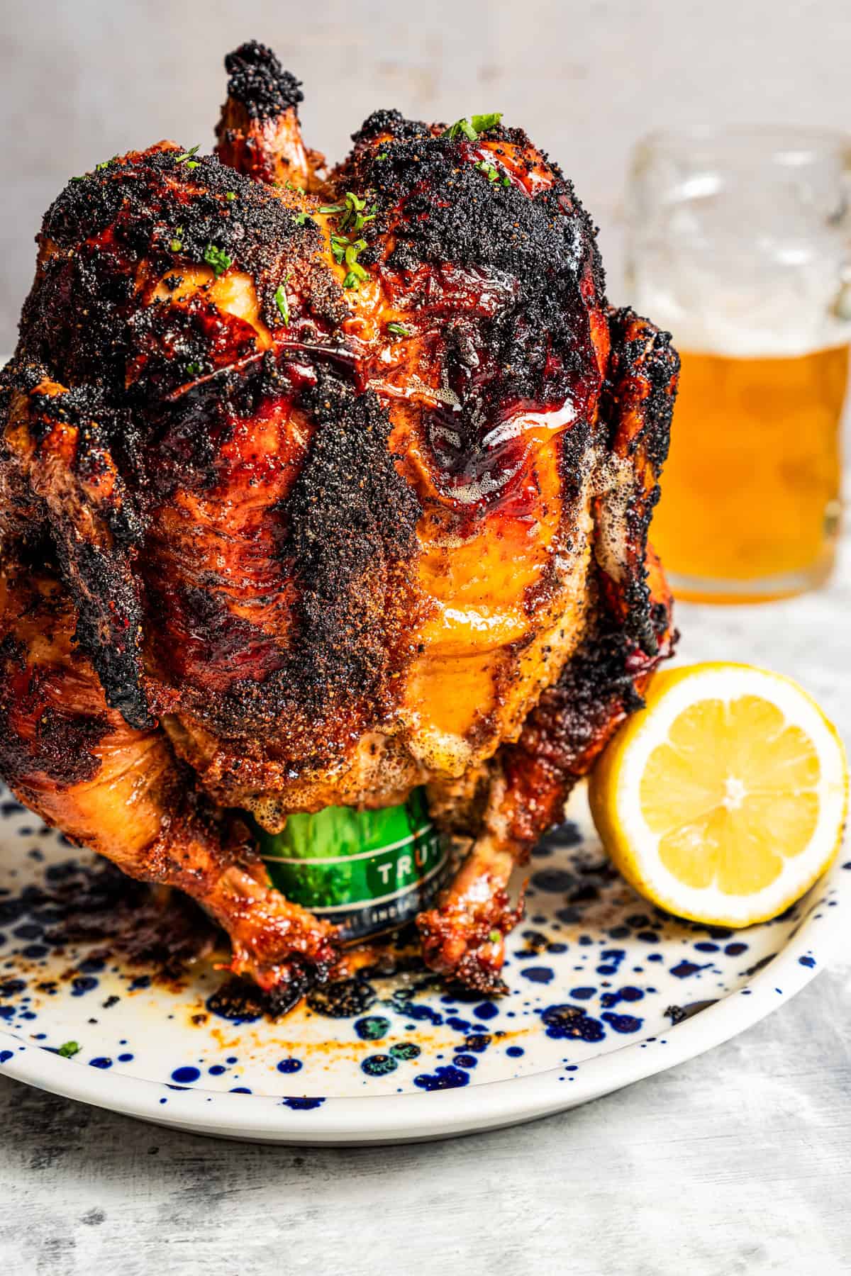 Whole cooked chicken propped up over a beer can.