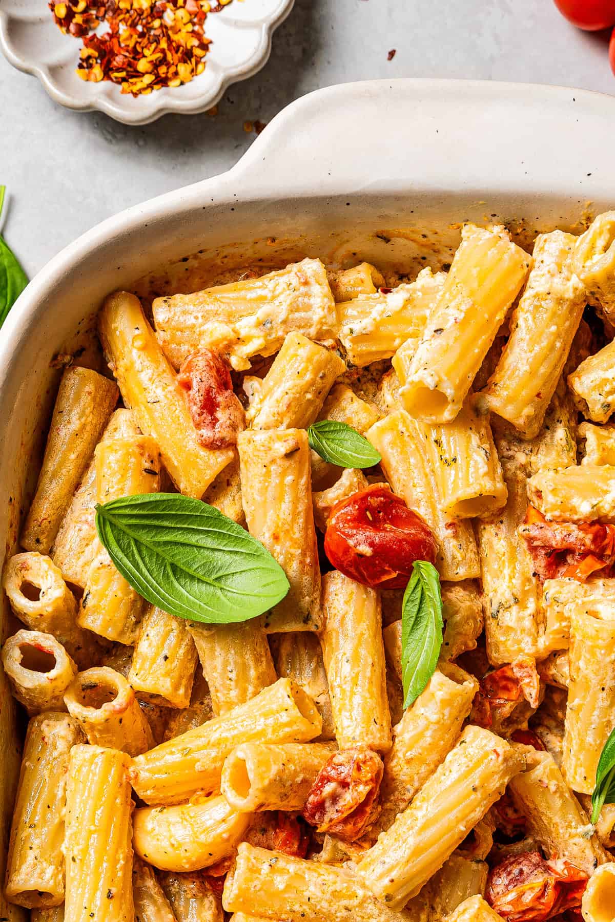 Close-up photo of baked Boursin pasta in a ceramic baking dish.