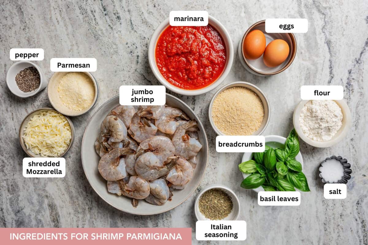 Shrimp parmigiana is crispy breaded shrimp baked over tangy marinara sauce with a golden, cheesy mozzarella crust. Perfect served with pasta! Ingredients for shrimp parmigiana with text labels set over each ingredient.