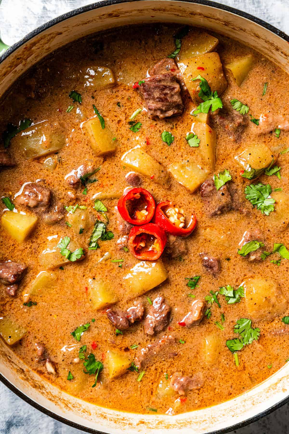 Overhead image of a pot with Thai Massaman curry.