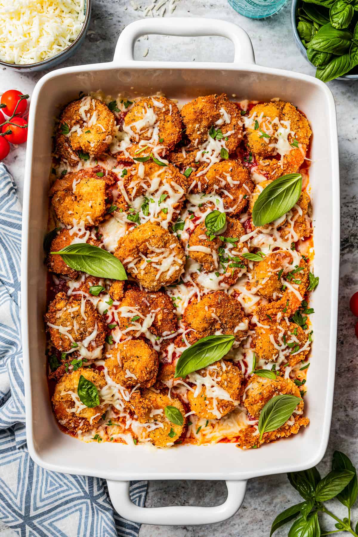 Parmesan shrimp in a white baking dish.