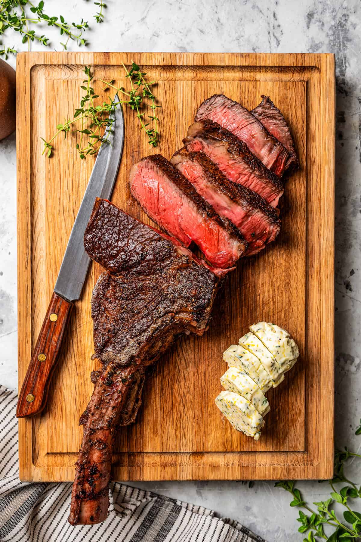 Slicing a steak on a wooden board.