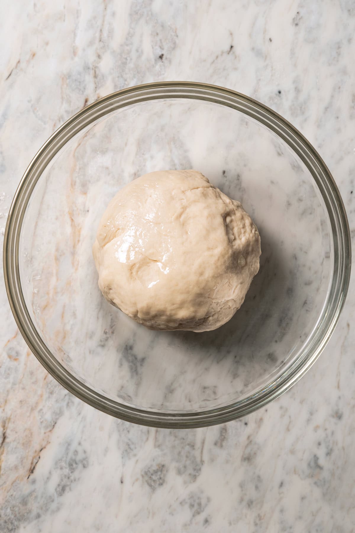 Bao bun dough in a glass bowl.