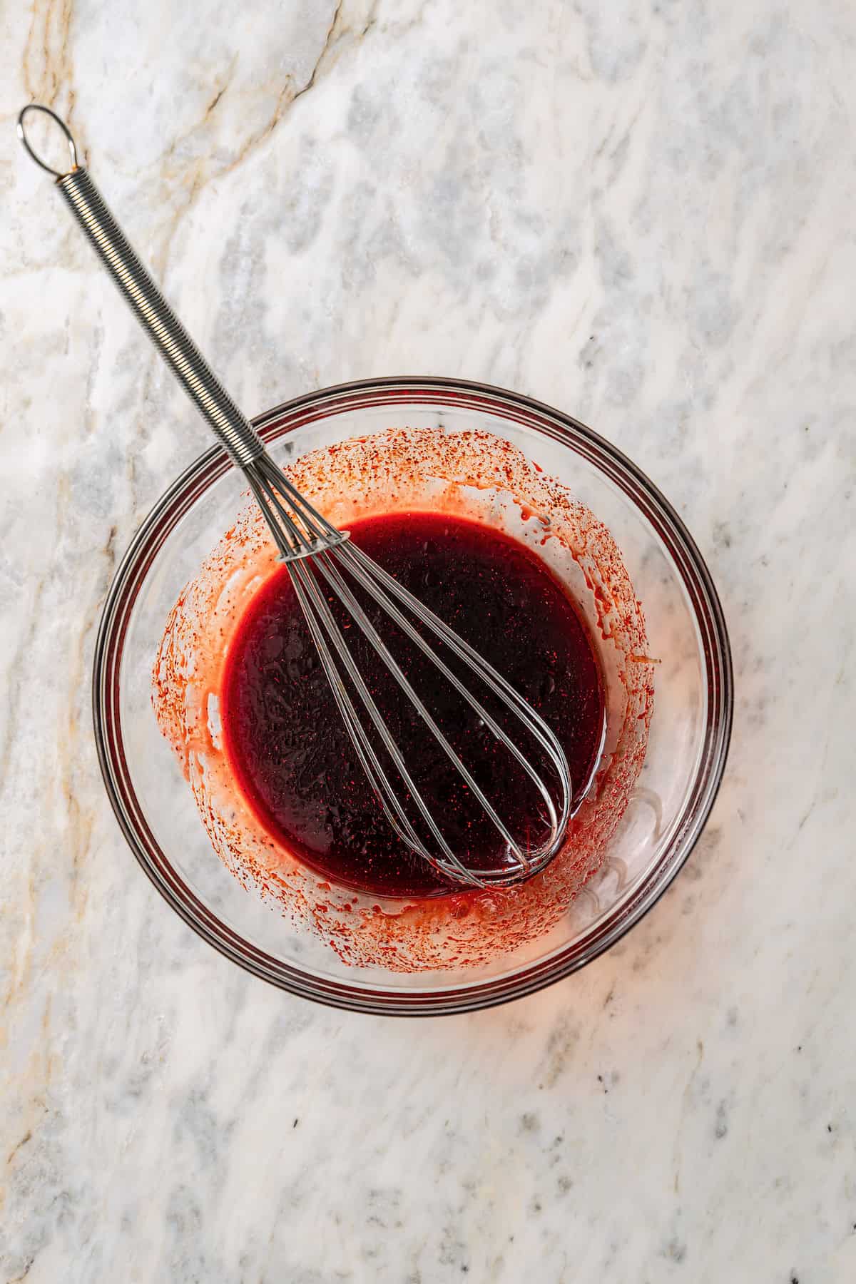 Char siu marinade in a glass bowl with a whisk.