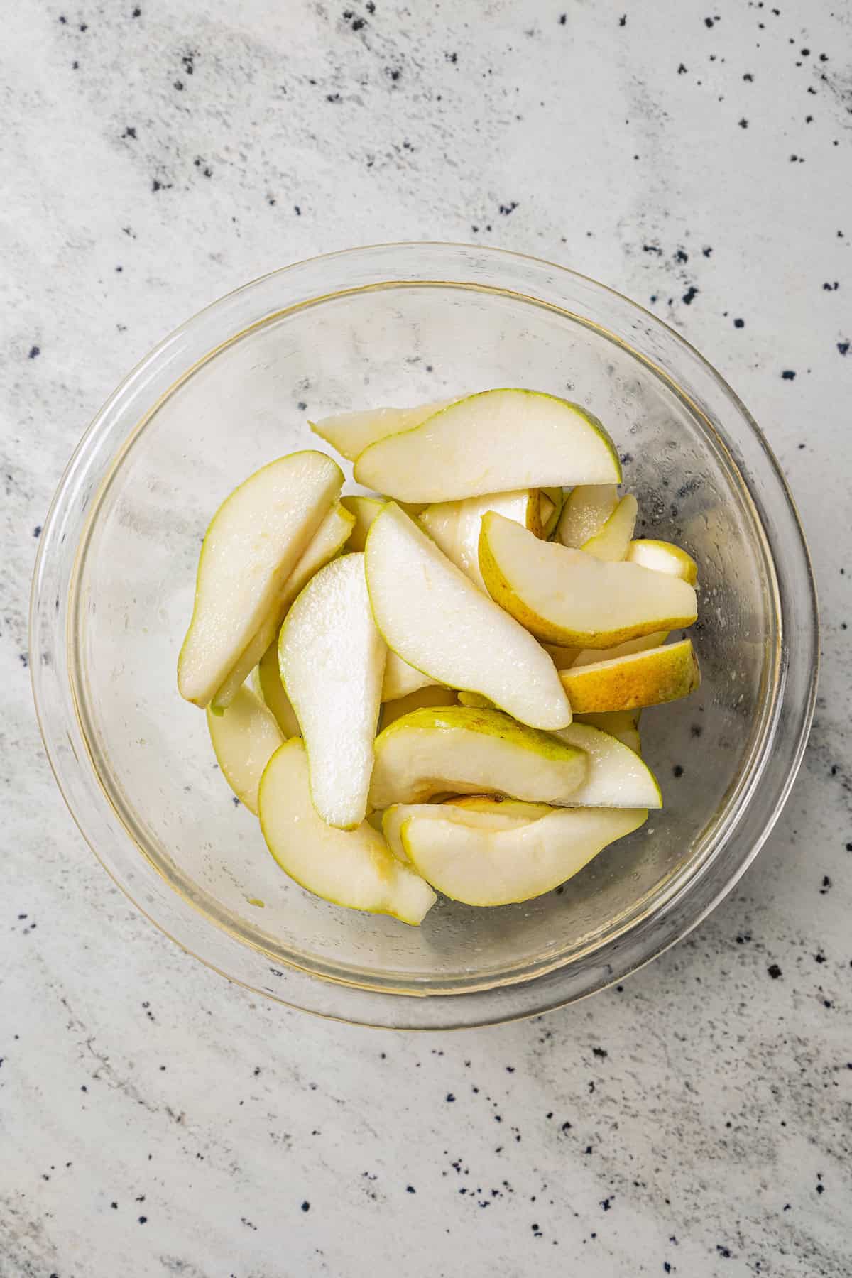 Sliced pears in a glass bowl.