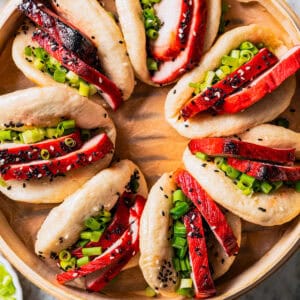 Overhead view of char siu bao buns in a steamer basket.