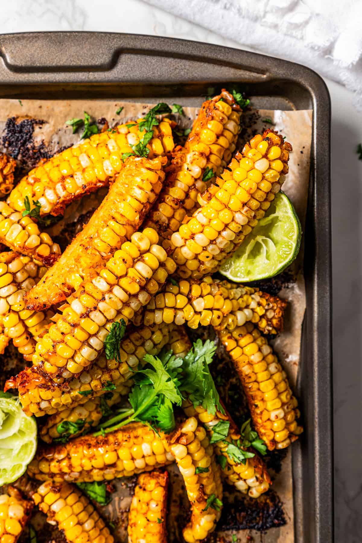 Corn ribs bunched together on a baking sheet.