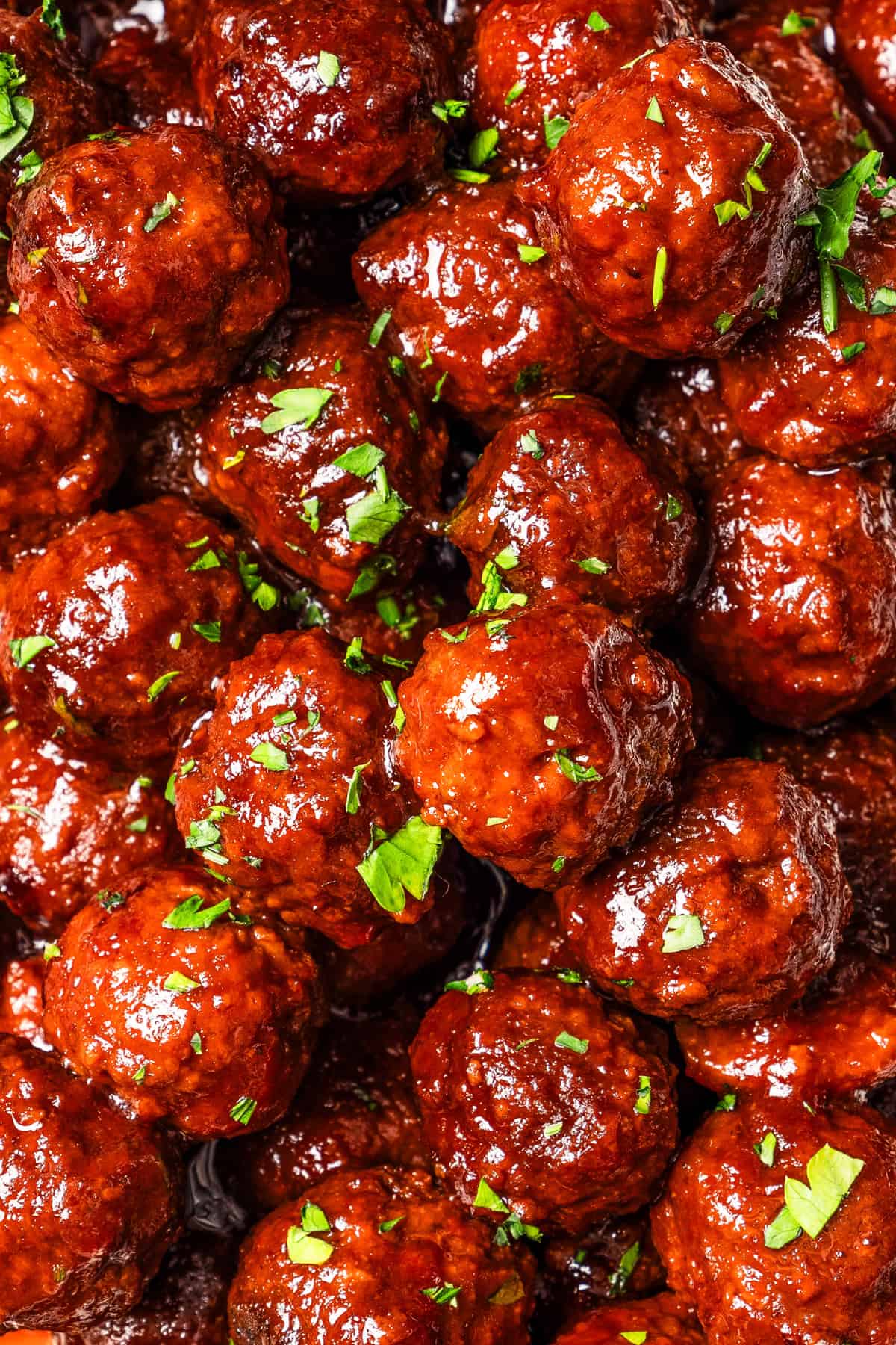 Close-up overhead view of grape jelly meatballs.