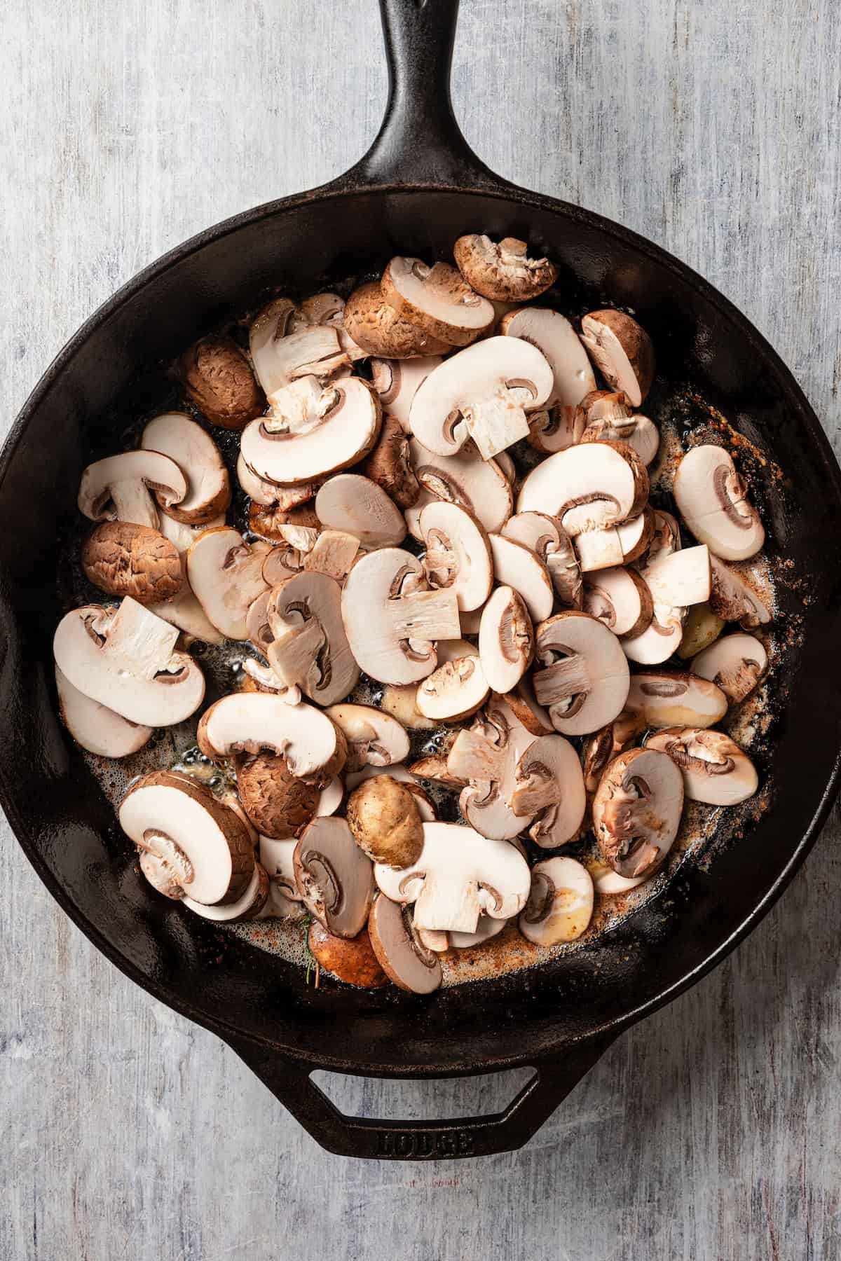 Cremini mushrooms in a skillet.