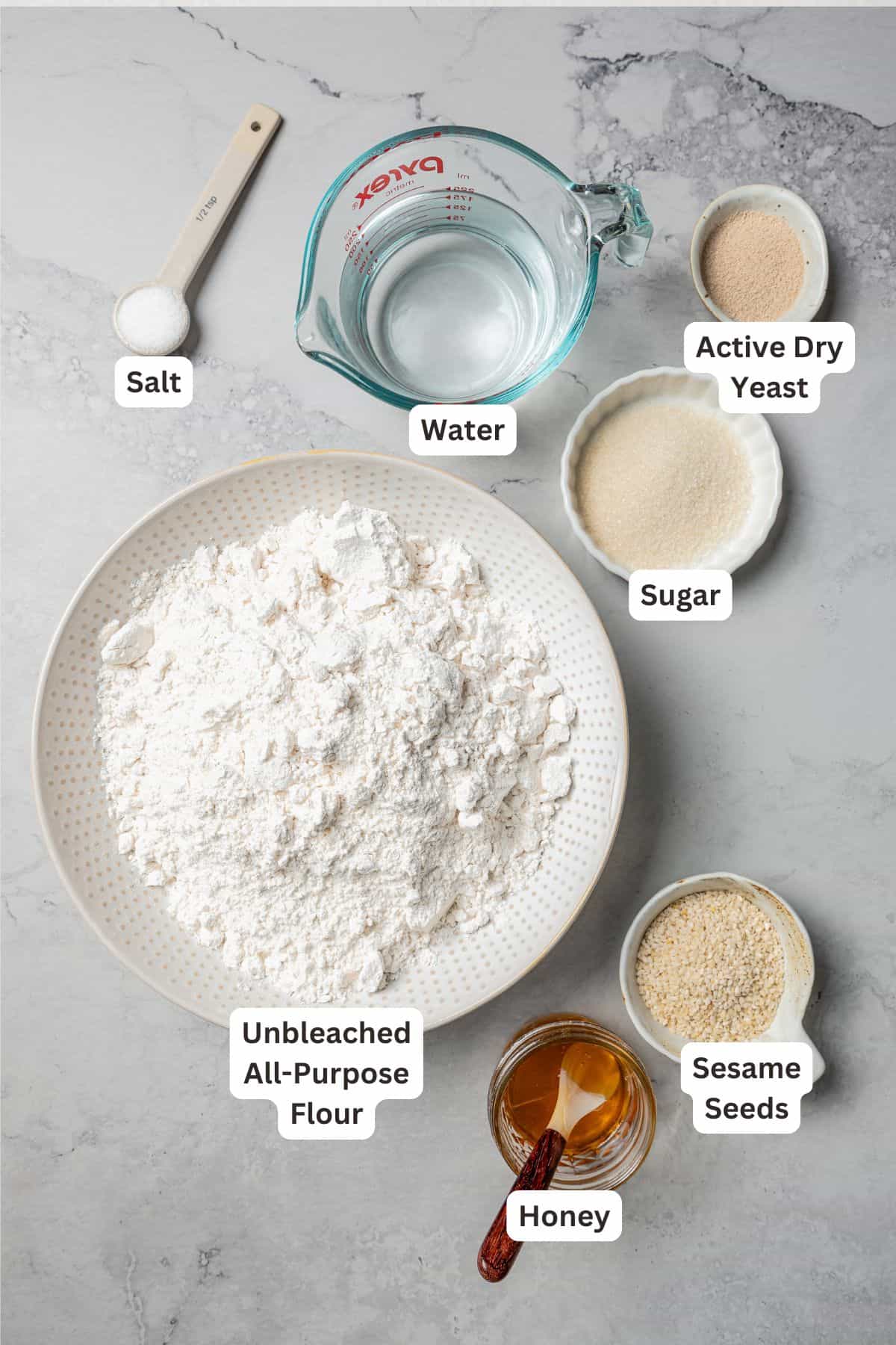 Ingredients for gevrek (sesame bagels) with text labels overlaying each ingredient.