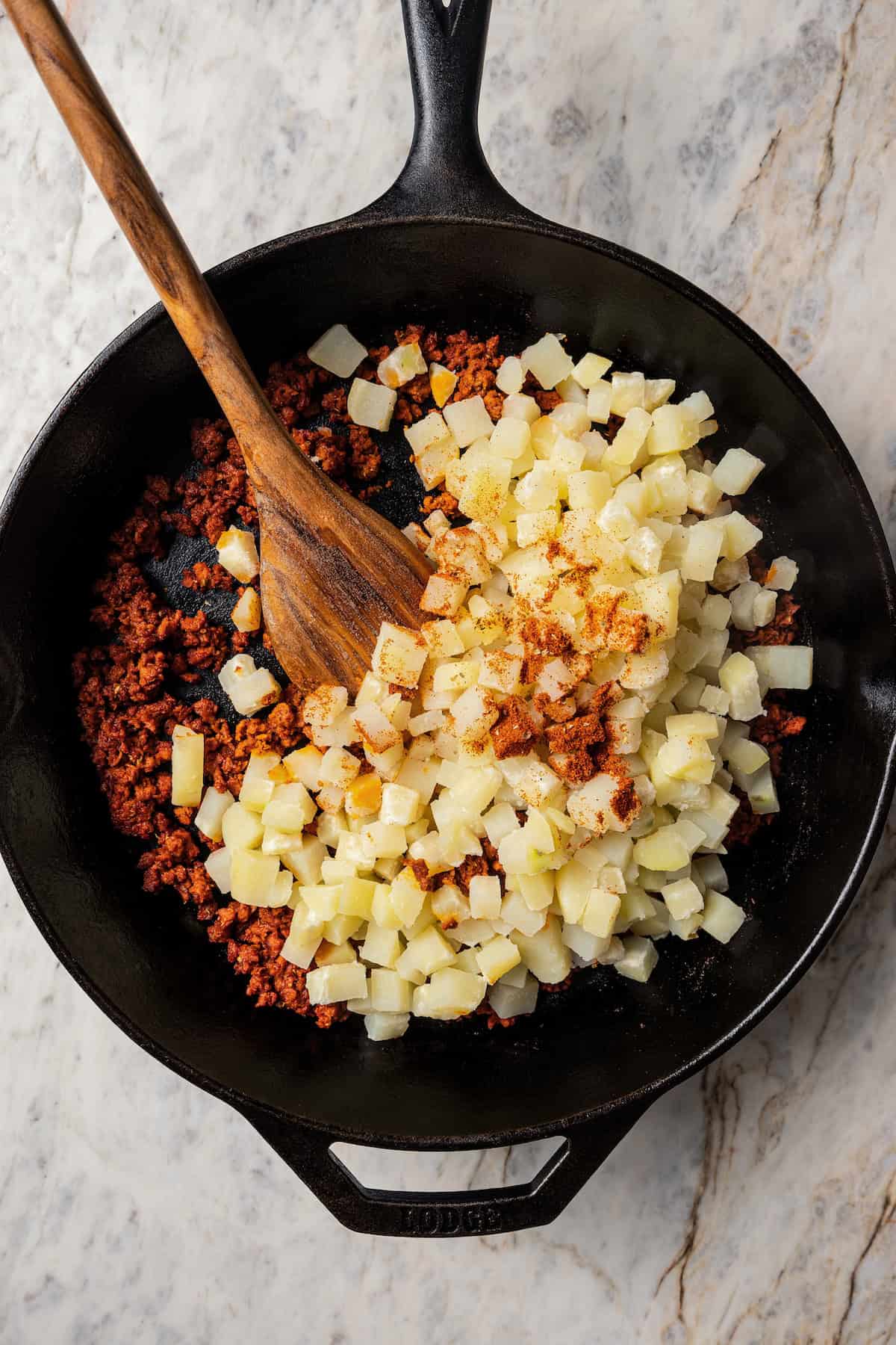 Chorizo and potatoes in a skillet.