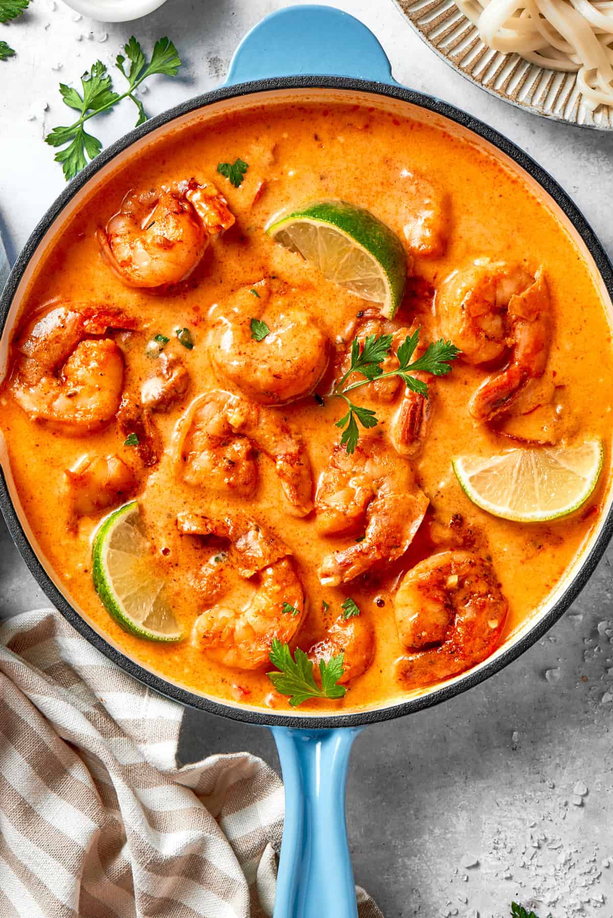 A skillet with shrimp in a cajun-flavored sauce.