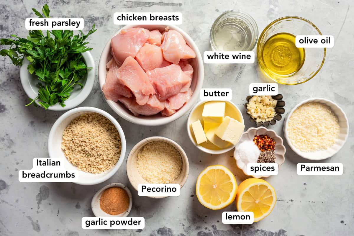 Chicken spiedini are Italian chicken skewers marinated with white wine and lemon zest, then breaded, skewered, and grilled until golden! Chicken spiedini ingredients with text labels overlaying each ingredient.