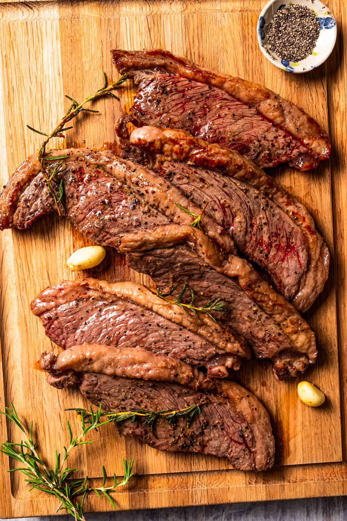 Resting cooked coulotte steaks on a cutting board.