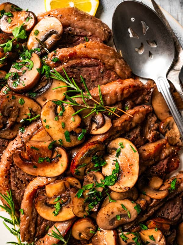 Coulotte steak topped with mushroom sauce and arranged on a serving platter.