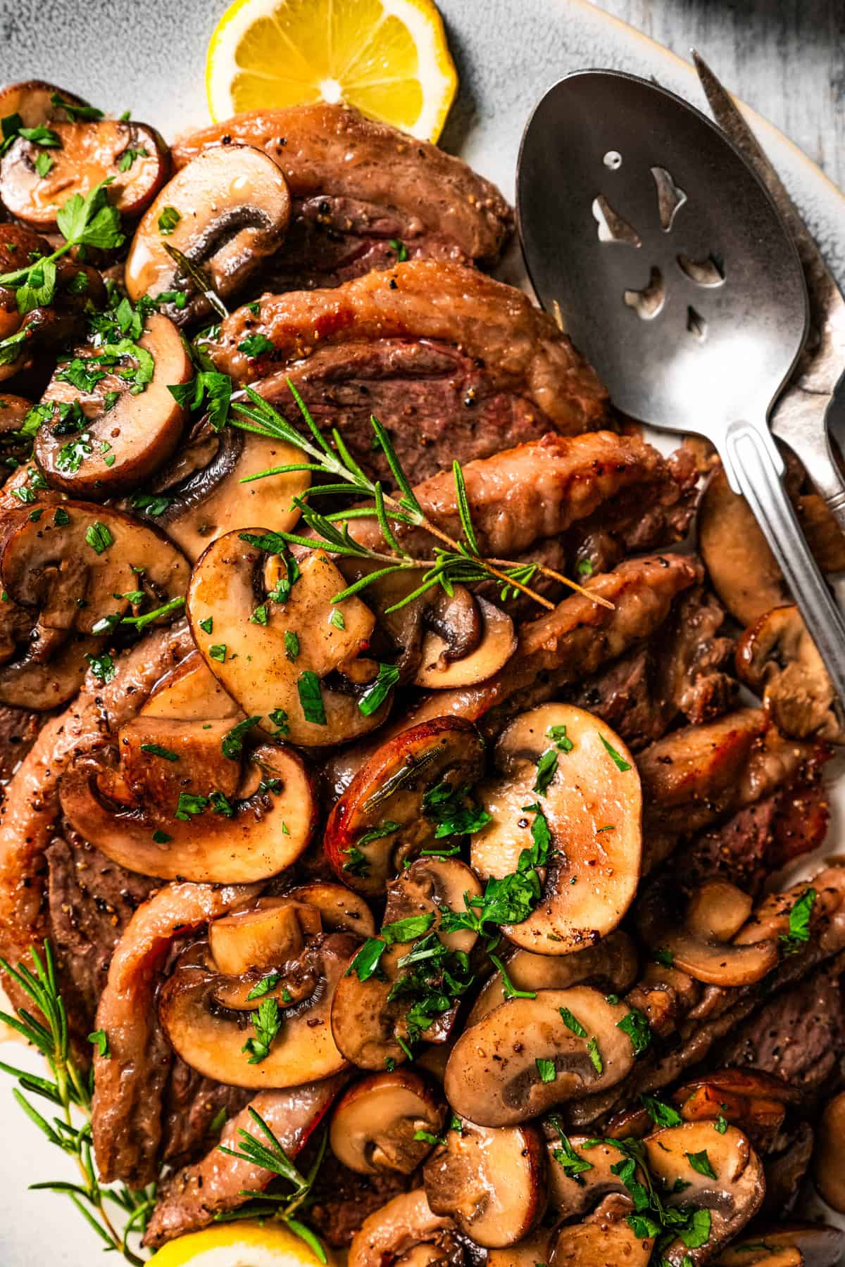 Coulotte steak topped with mushroom sauce and arranged on a serving platter.