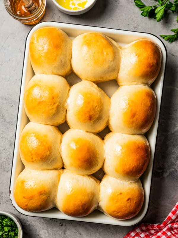 Freshly baked dinner rolls on a baking sheet.