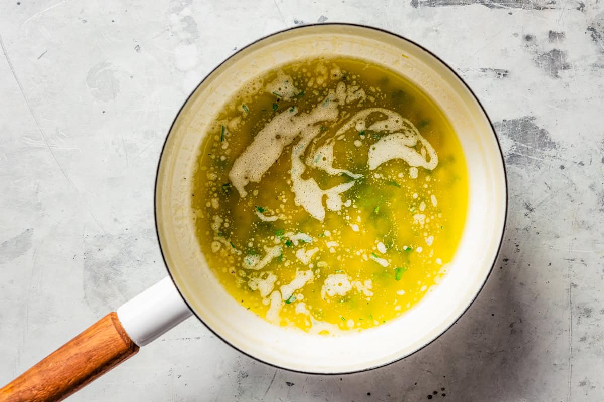 Chicken spiedini are Italian chicken skewers marinated with white wine and lemon zest, then breaded, skewered, and grilled until golden! Lemon butter sauce in a saucepan.