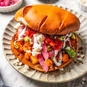 Pambazos sandwich served on a dinner plate.