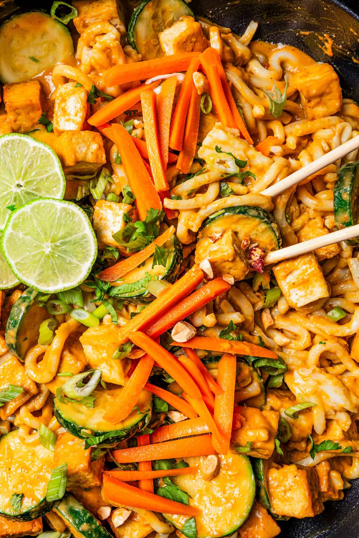 Close-up image of peanut noodles in a pan.