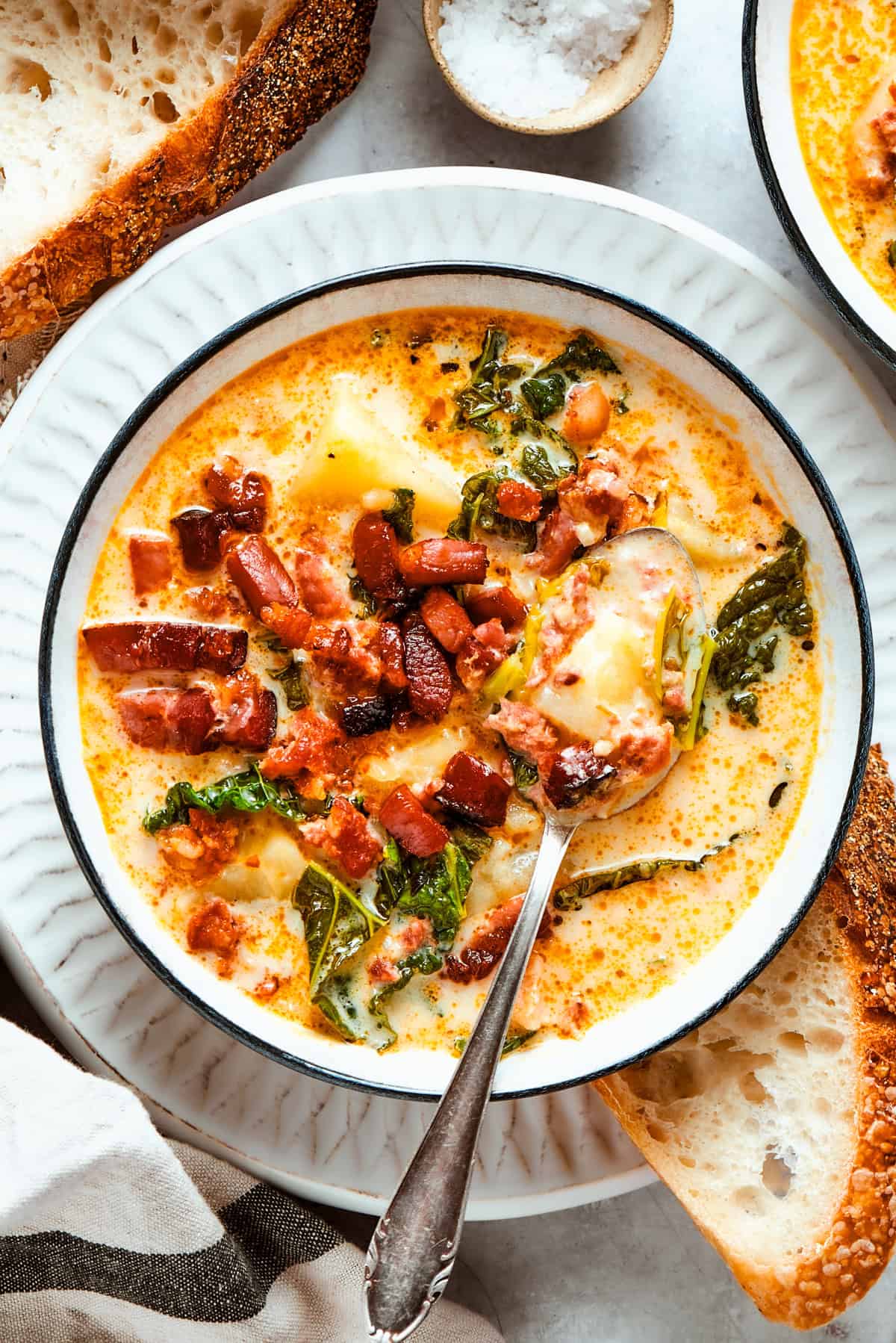 Zuppa Toscana served in a bowl and topped with bacon bits.