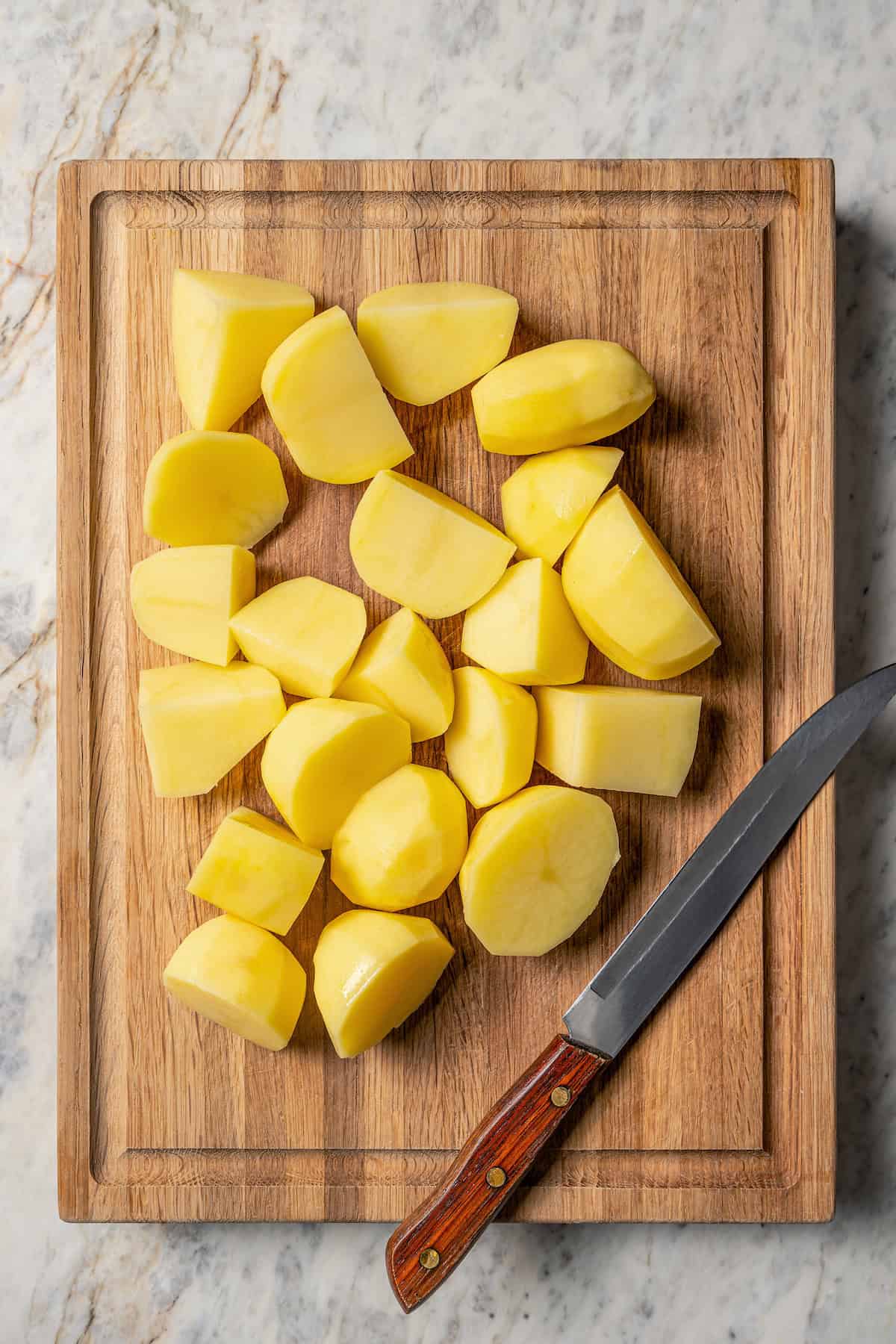 Chopped Yukon gold potatoes on a cutting board.