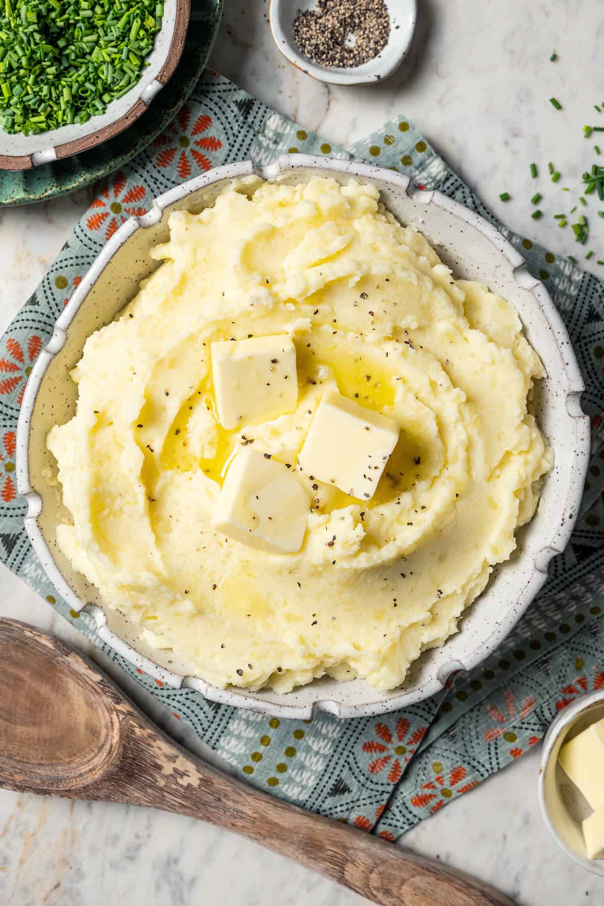 Buttermilk mashed potatoes in a bowl with butter.