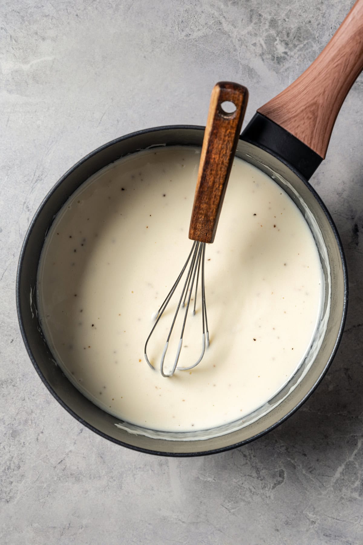 The roux in a pot with cream.