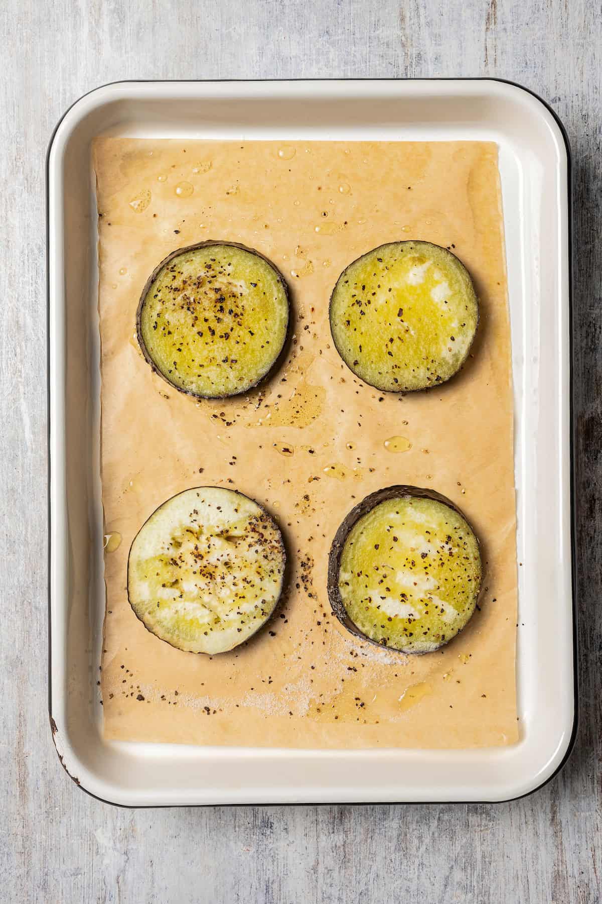 Roasted eggplant pieces on a baking sheet.