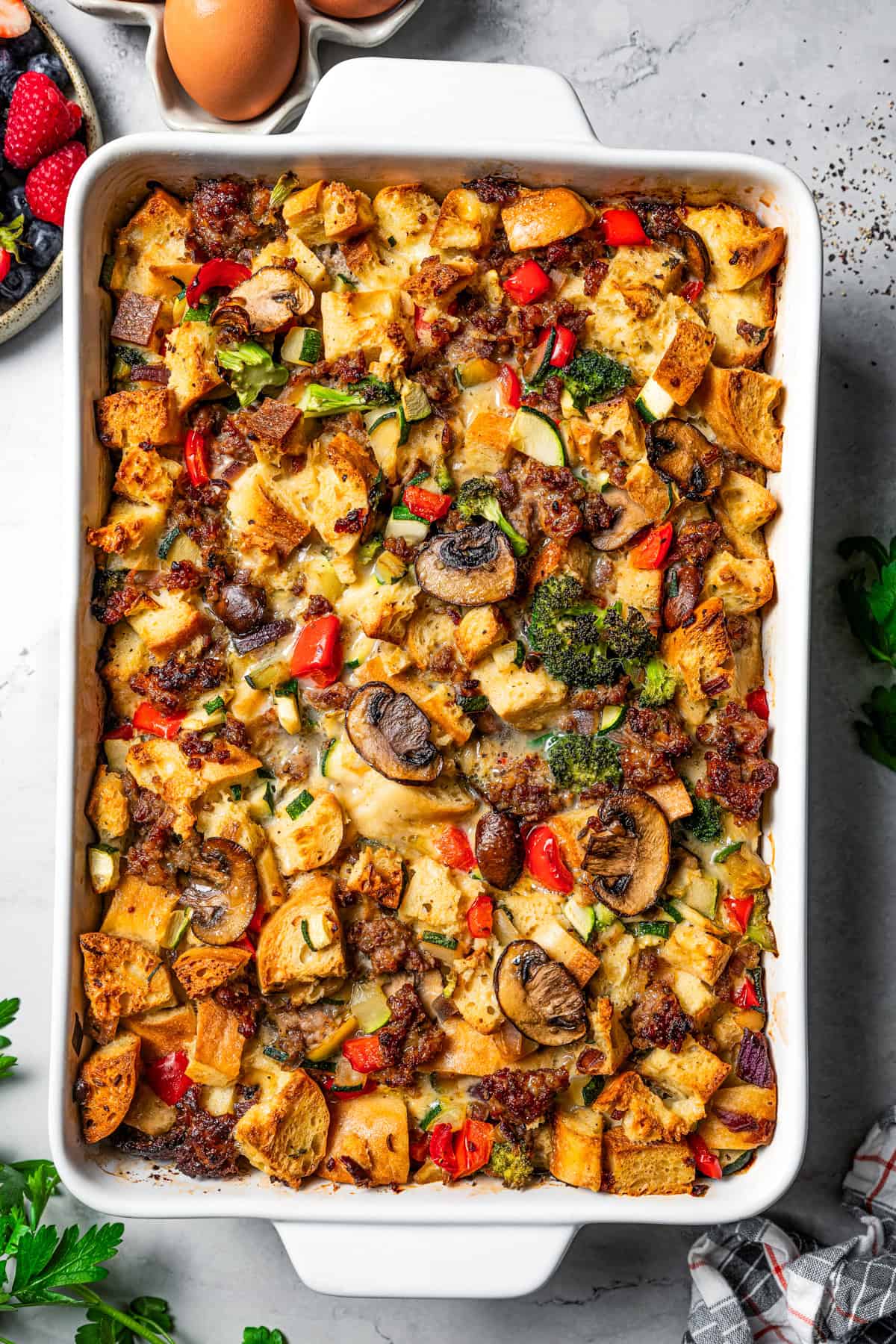 Baked breakfast casserole with sausage in a baking dish.