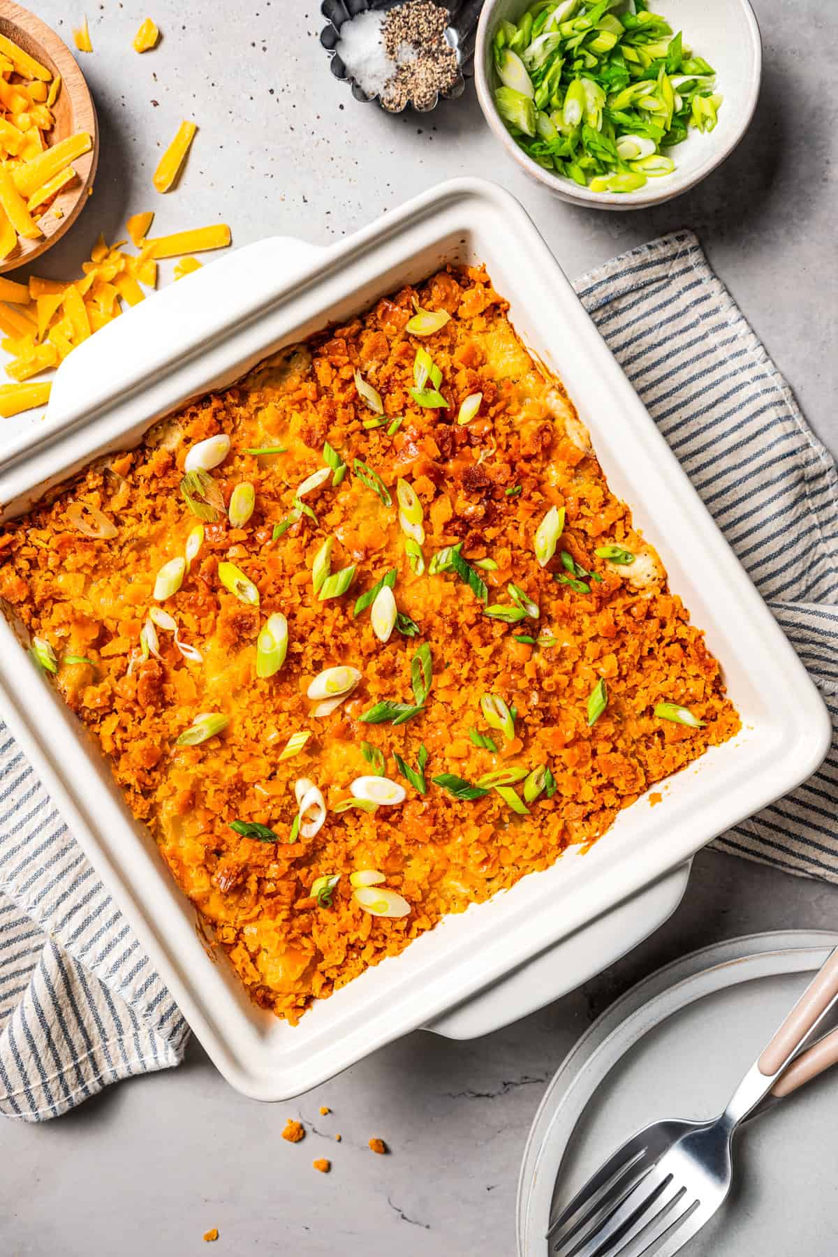 Overhead view of baked cheesy potatoes in a baking dish.