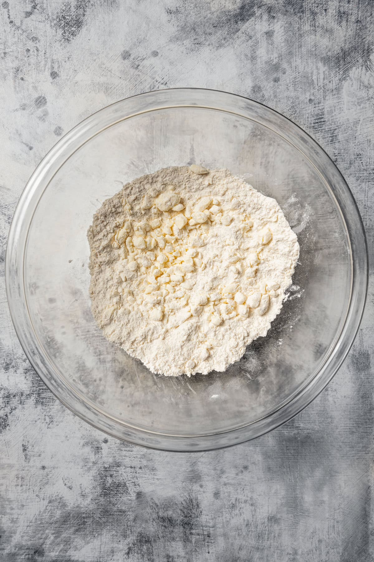 Butter cut into flour in a class bowl.