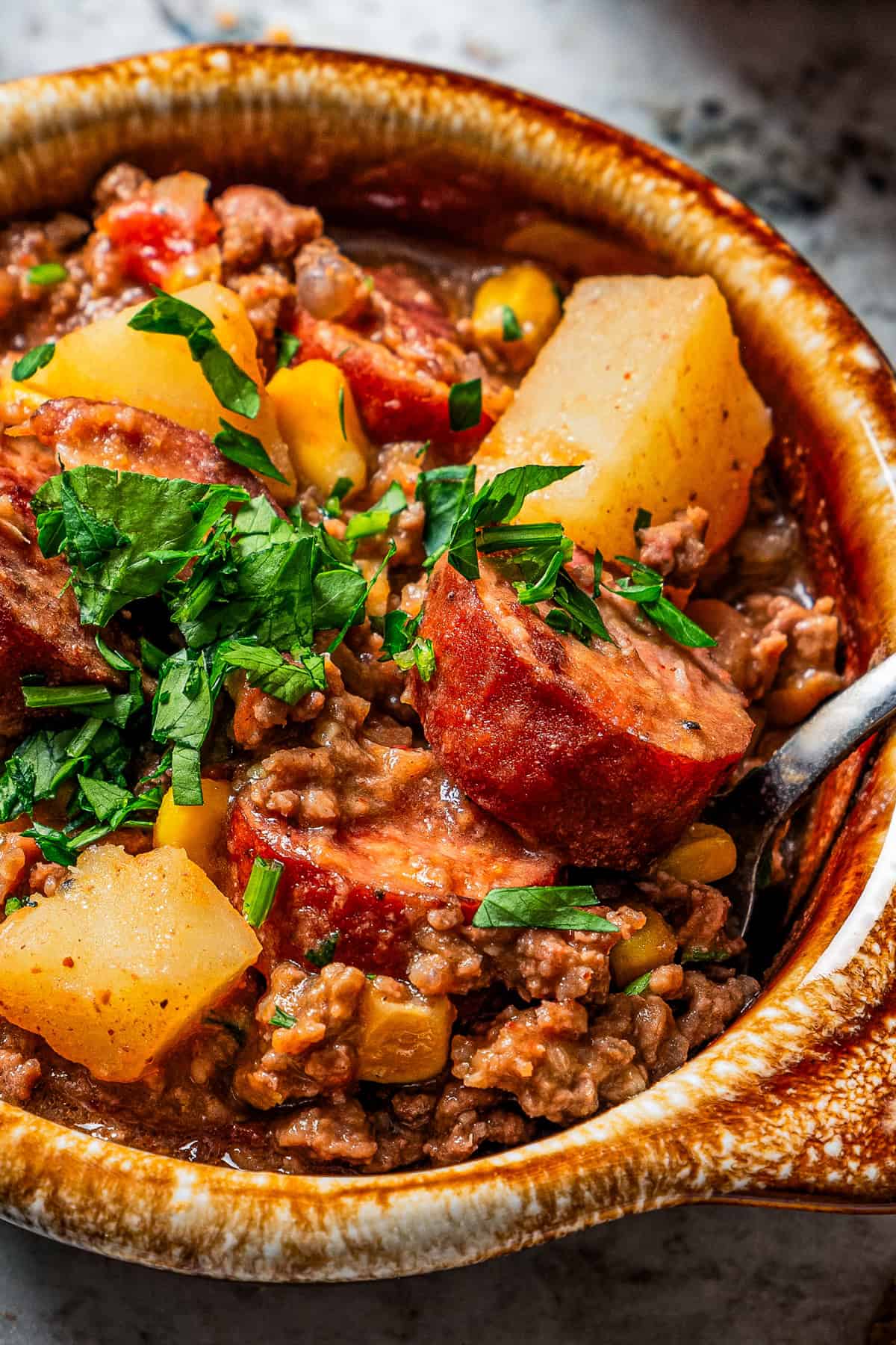 Cowboy stew served in a bowl and garnished with fresh cilantro.