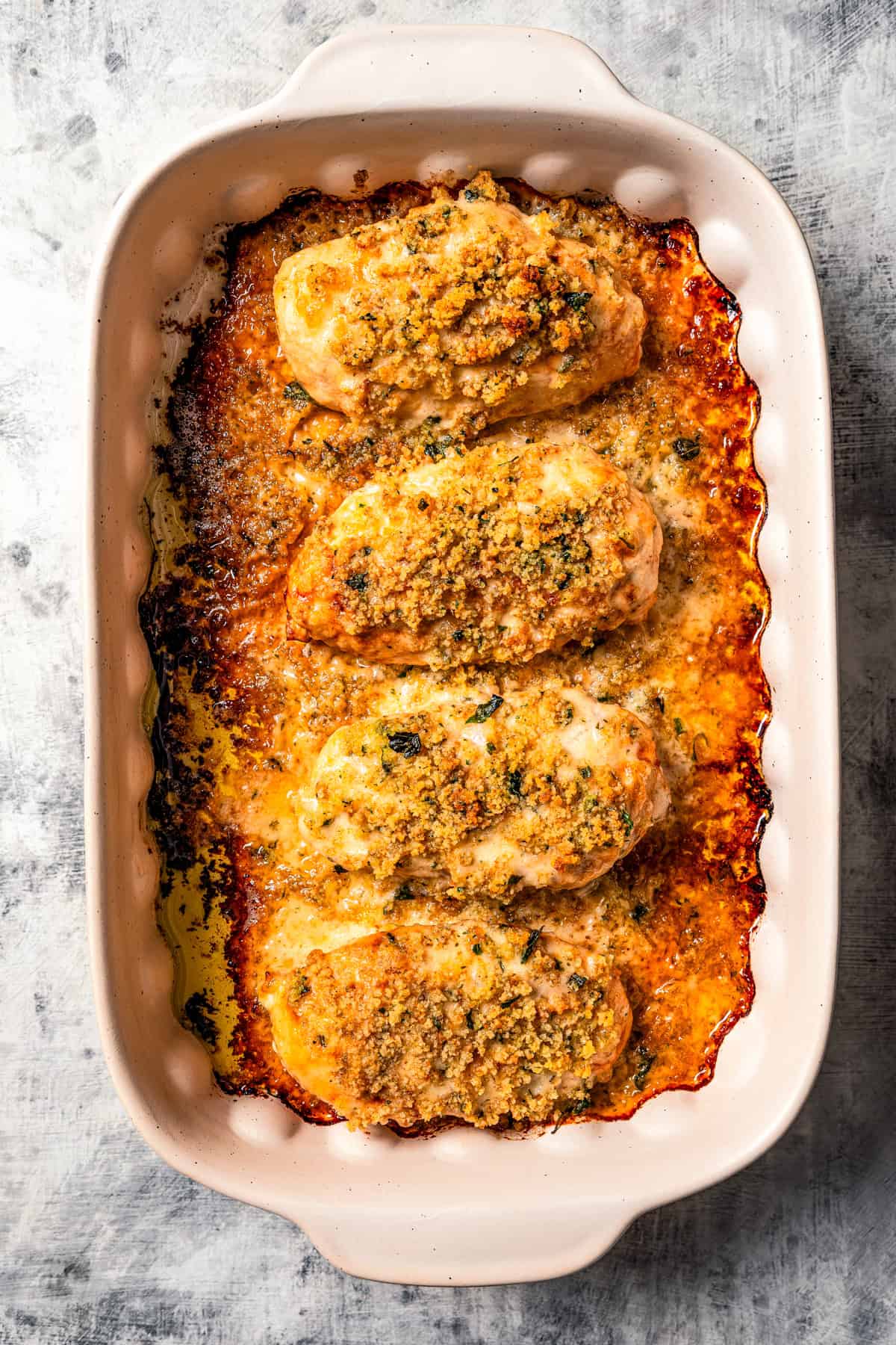 Baked parmesan crusted chicken in a baking dish.