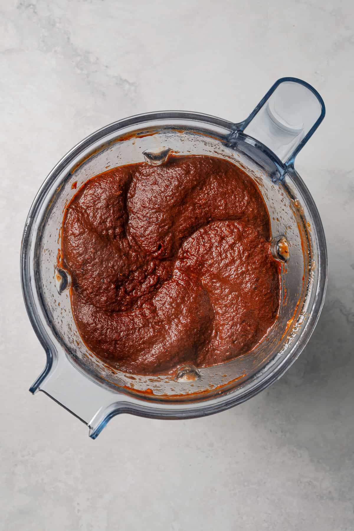 Birria sauce being processed inside a blender.