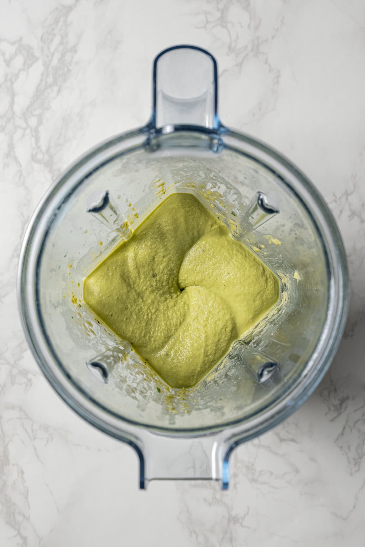 Hummus being processed inside a blender.