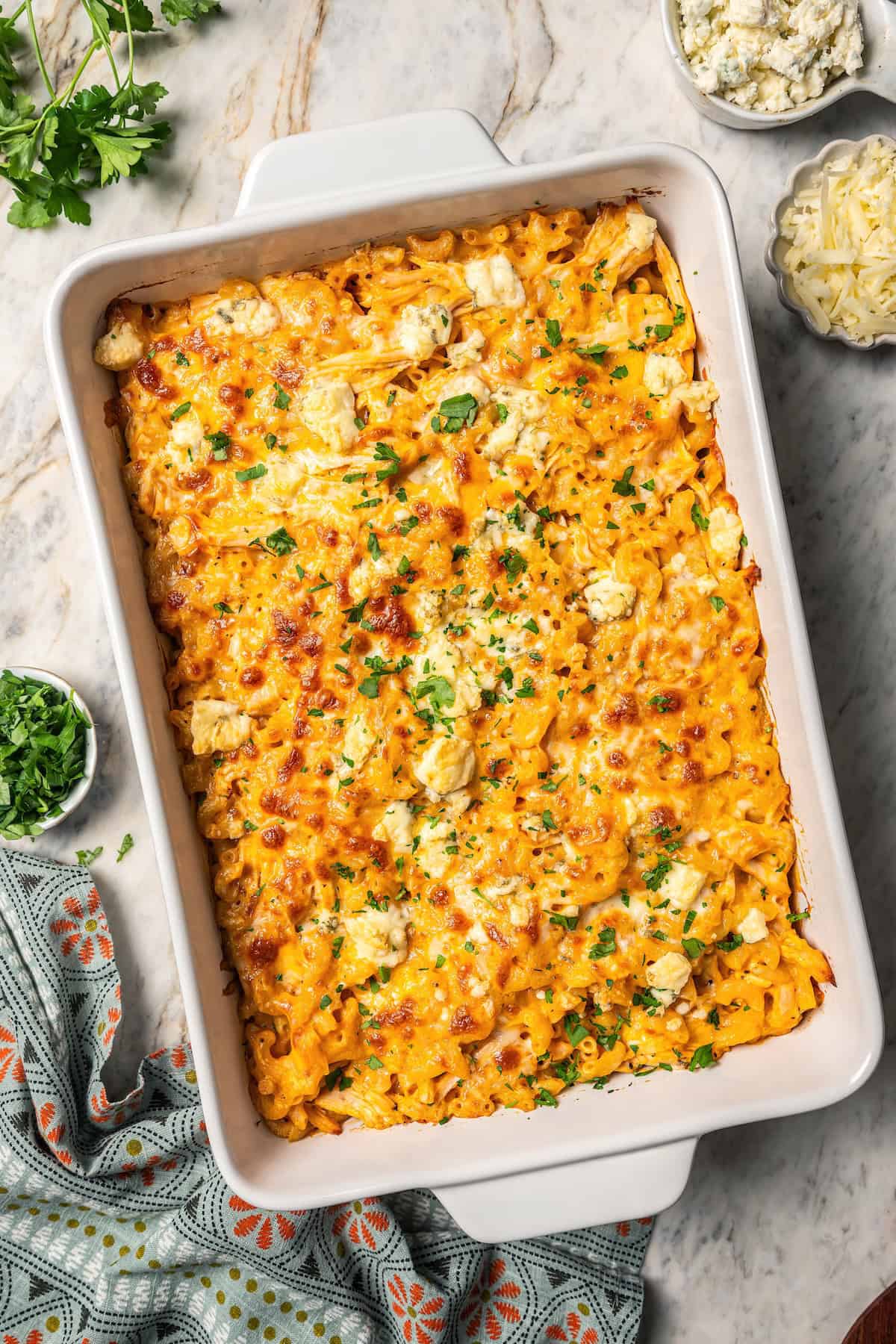 Overhead view of baked buffalo mac and cheese in a casserole dish.