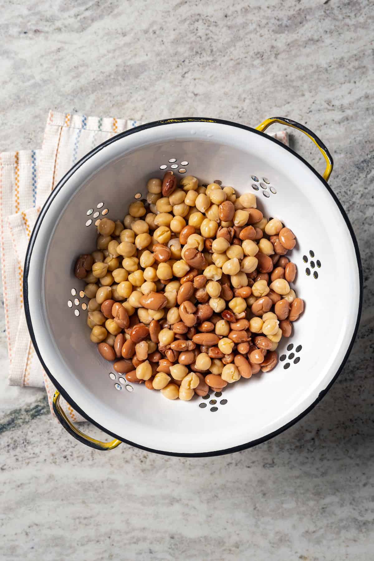 Drained and rinsed mixed beans in a white colander.