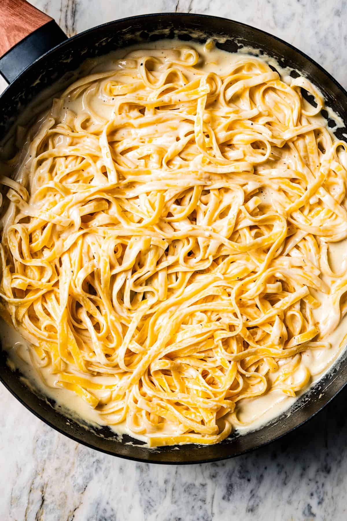 Fettuccine alfredo in a skillet.