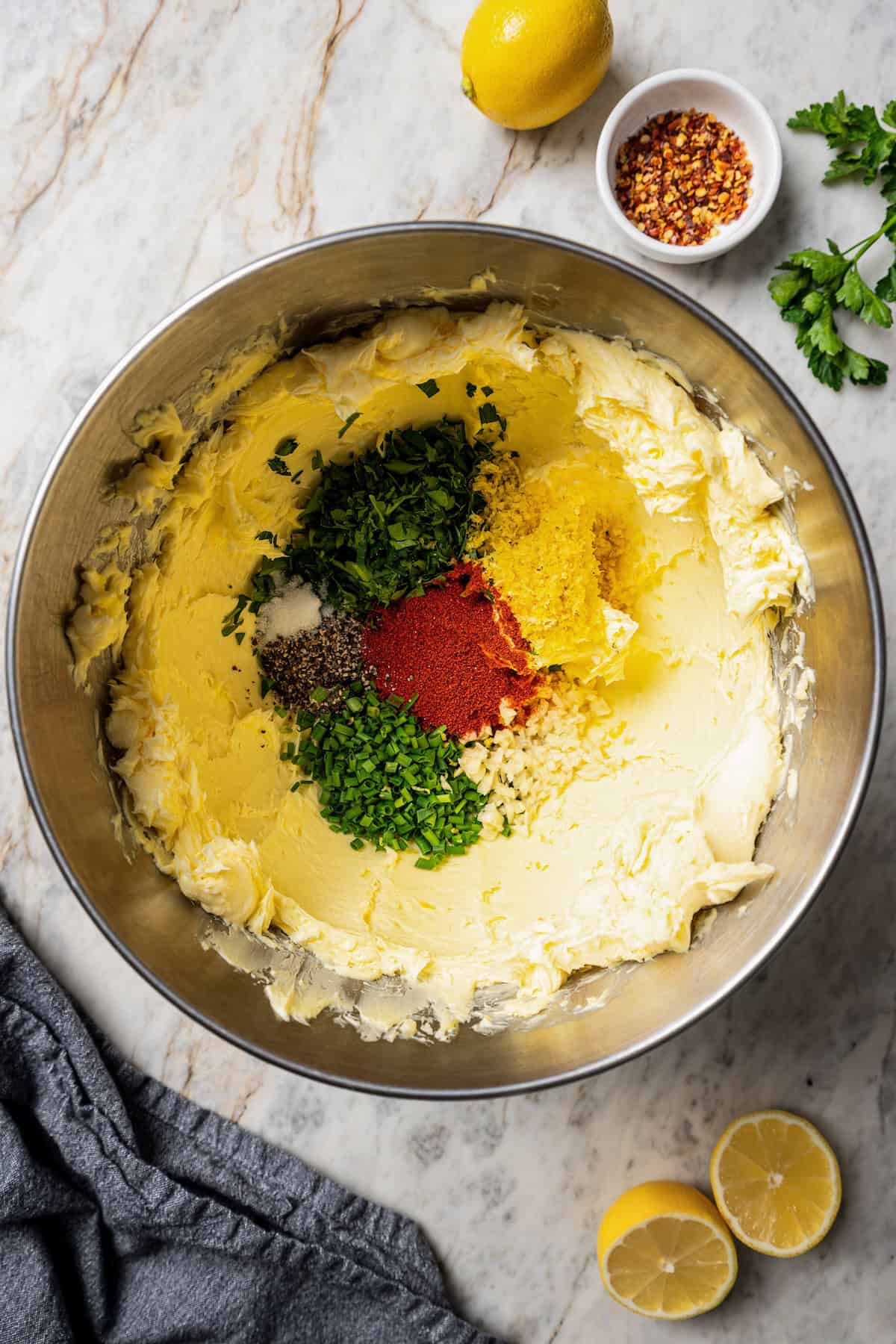 Cowboy butter ingredients combined in a metal bowl.