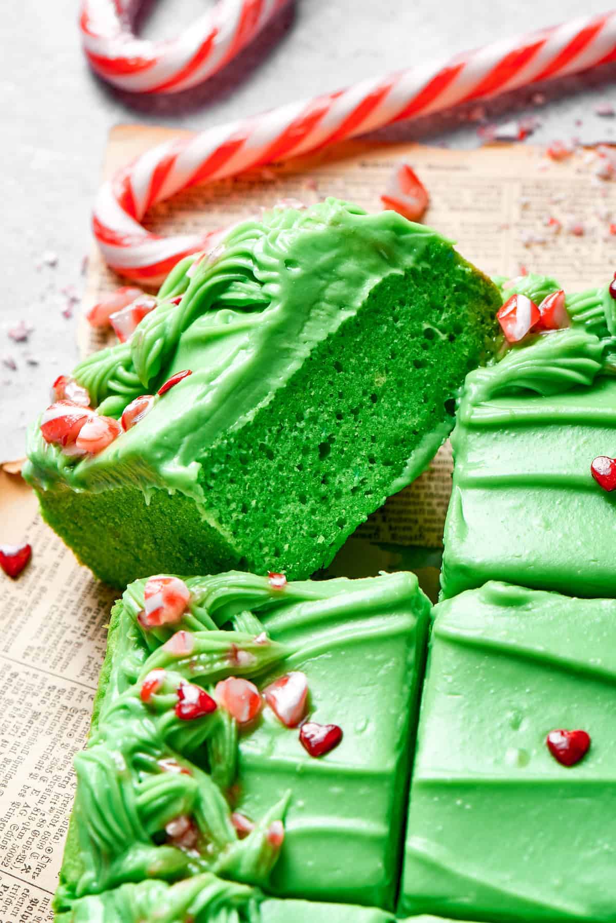 Green colored cake cut into squares. 