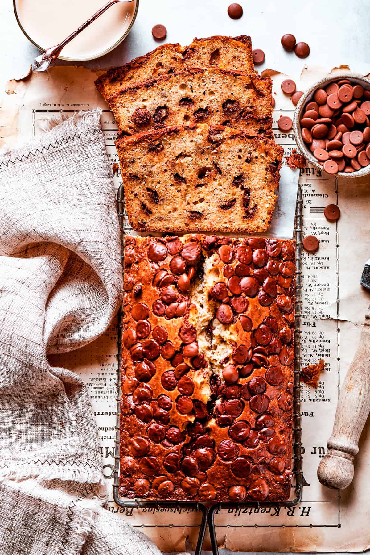 Banana Chocolate Chip Bread, sliced, and set on a table.