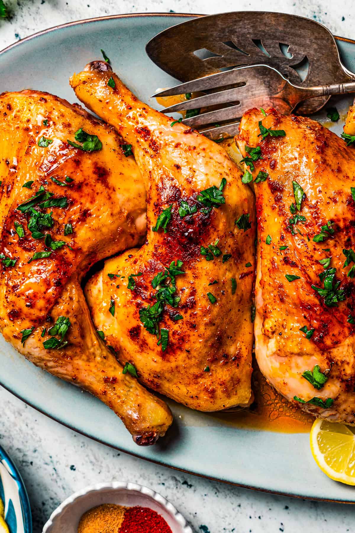 Roasted chicken leg quarters arranged on a plate.