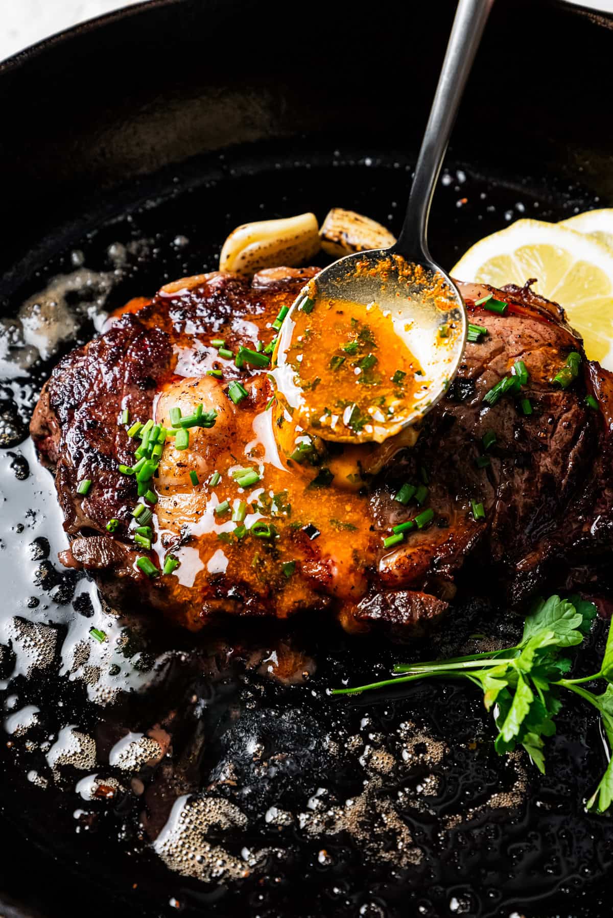 Basting a steak with cowboy butter.