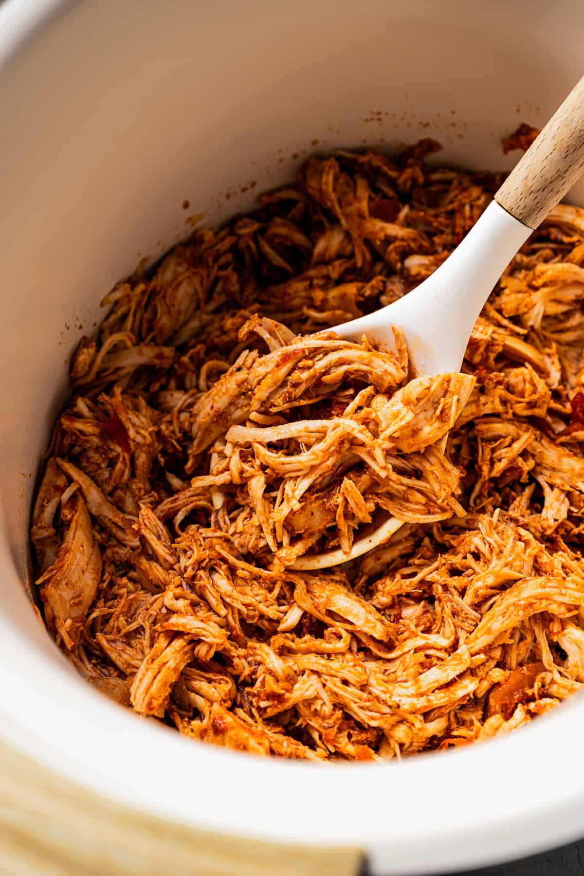 Pulled chicken inside the crock pot.