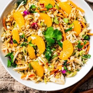 Overhead view of ramen salad in a large bowl garnished with mandarin oranges.