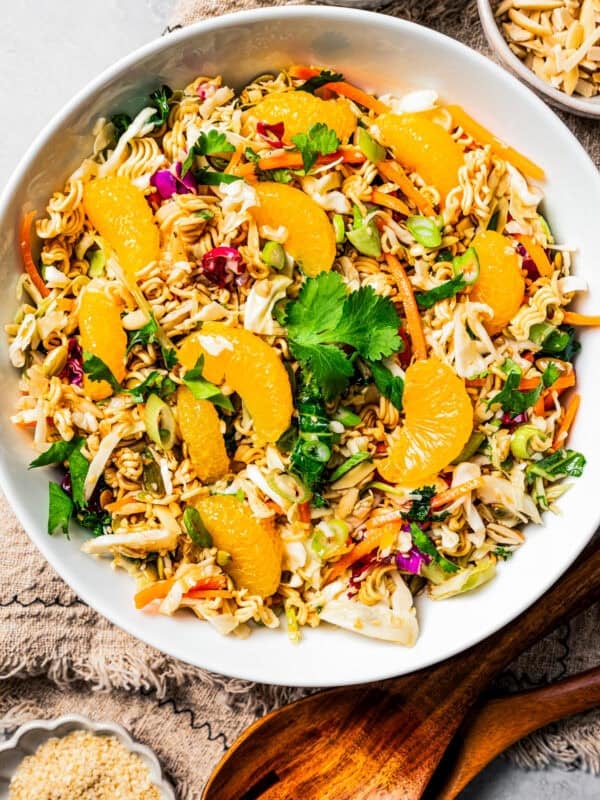 Overhead view of ramen salad in a large bowl garnished with mandarin oranges.