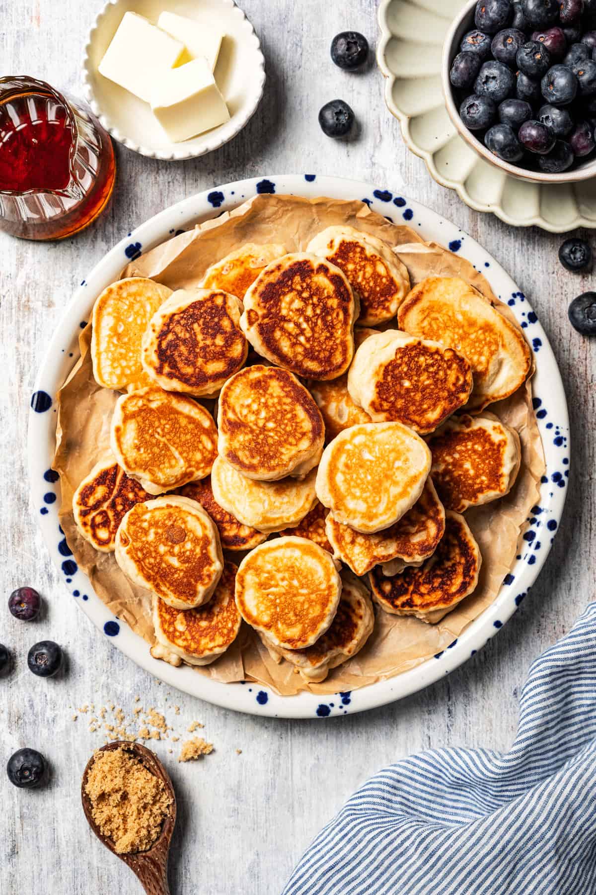 A pile of silver dollar pancakes served on a plate.