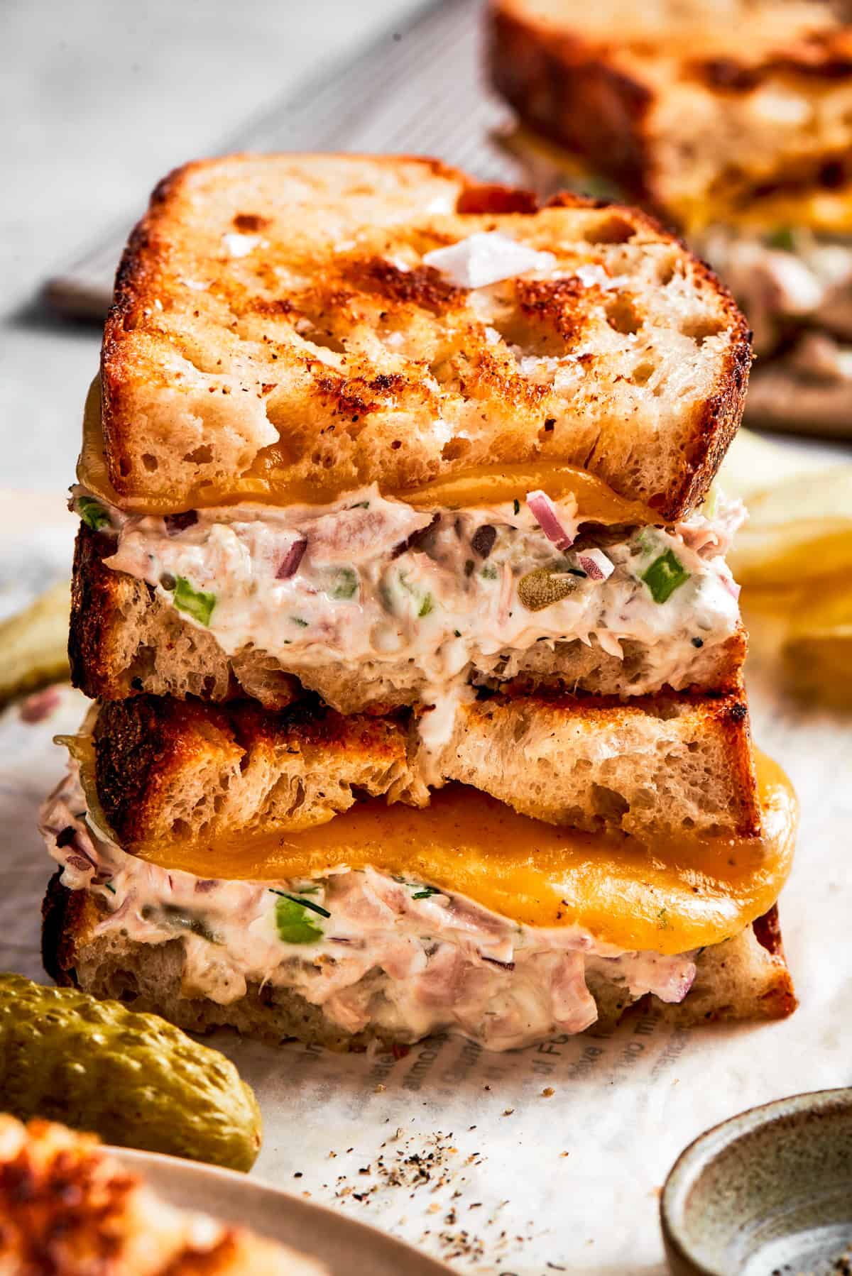 Two tuna melt sandwiches stacked up.